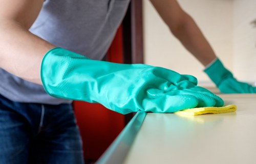 Cleaner wearing PPE during a carpet cleaning job